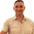 Richard Kurylo with short hair and a short-sleeved tan top