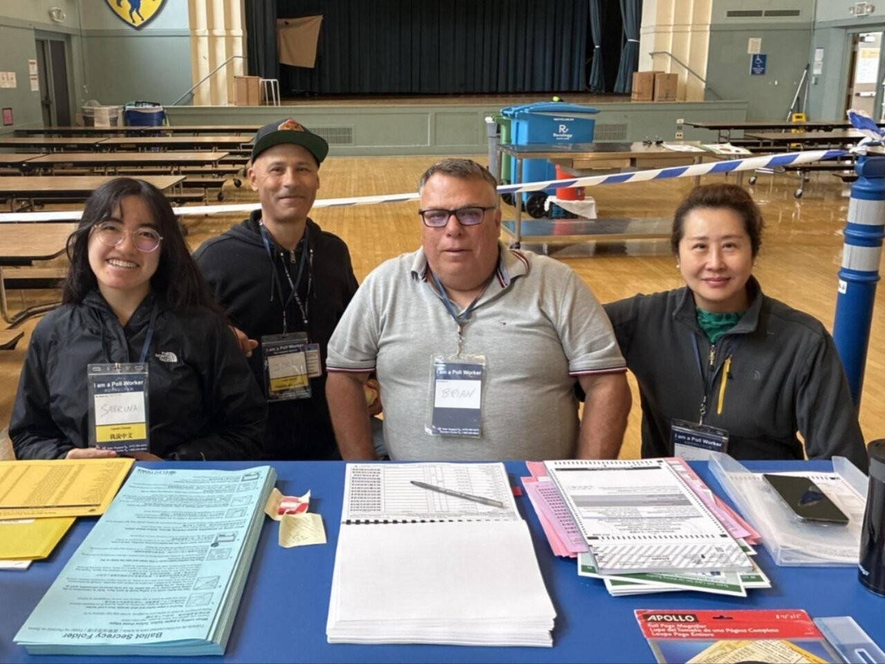 Poll workers sitting at a polling place
