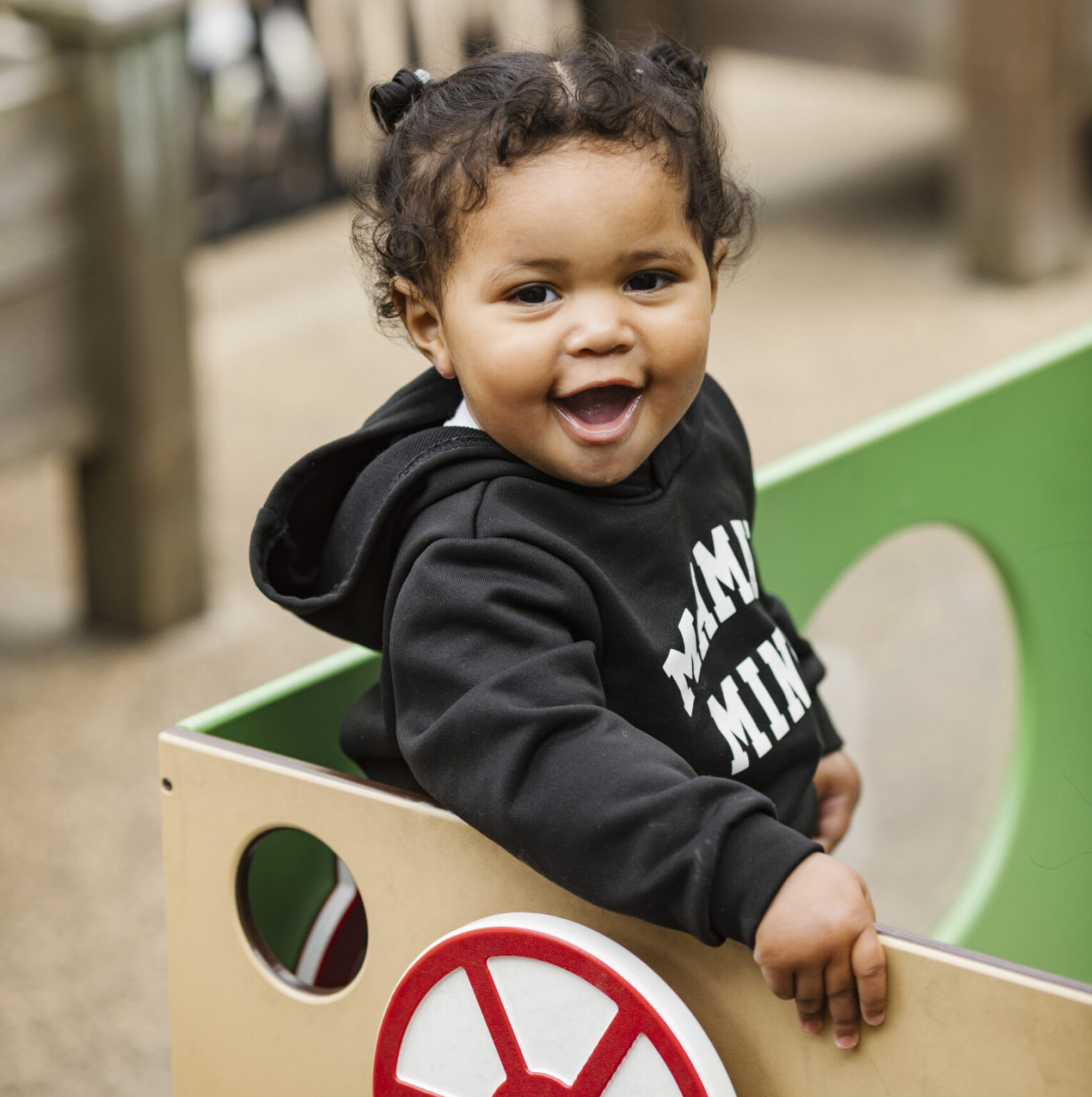 Toddler smiling on a playground