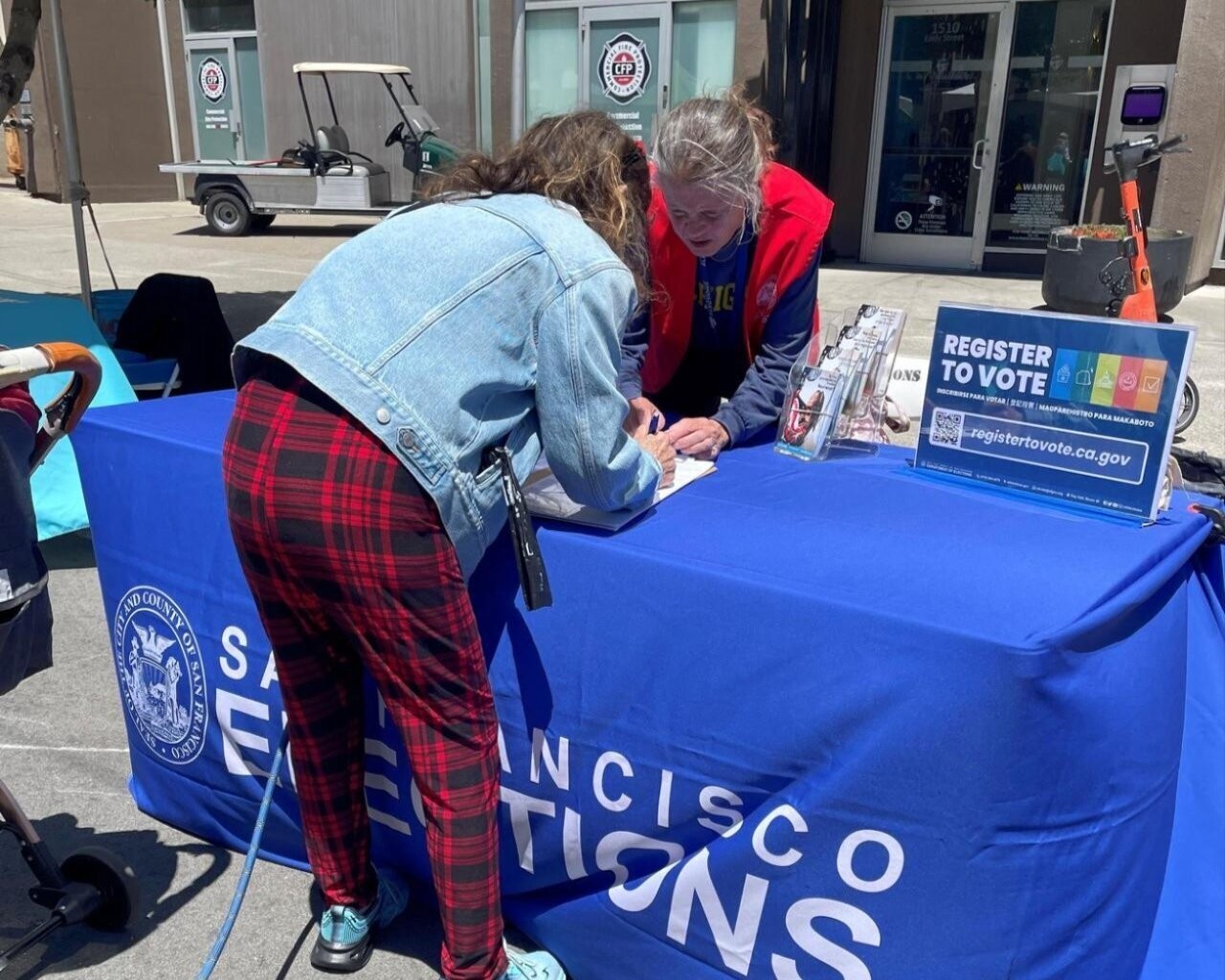 Outreach staff assisting a resident to register to vote