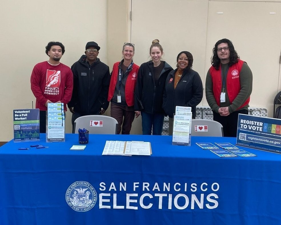 Outreach staff posing with PHC staff at an outreach event