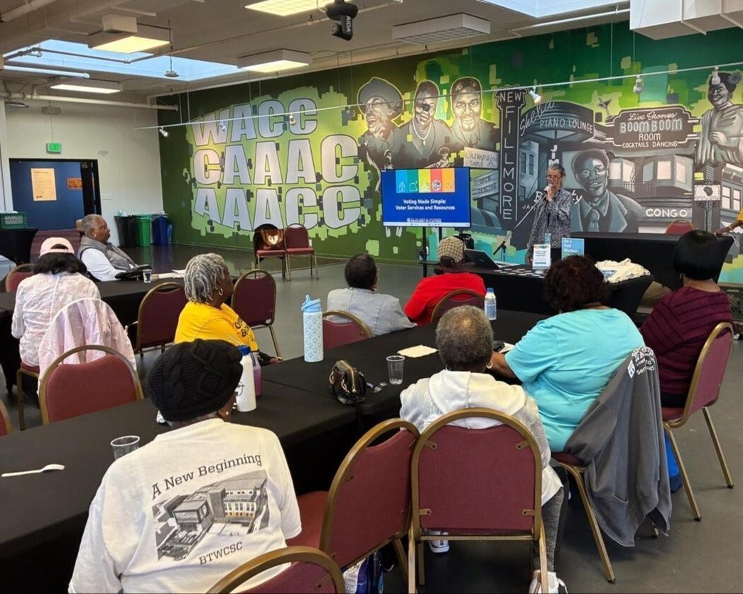 Elections staff presenting a slideshow to a group of 20 SF residents.
