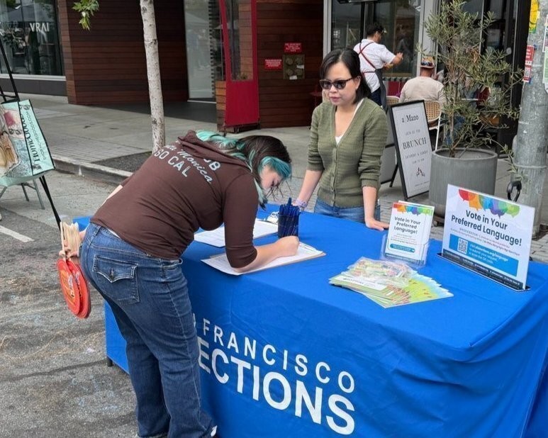Elections staff registering an SF resident to vote.