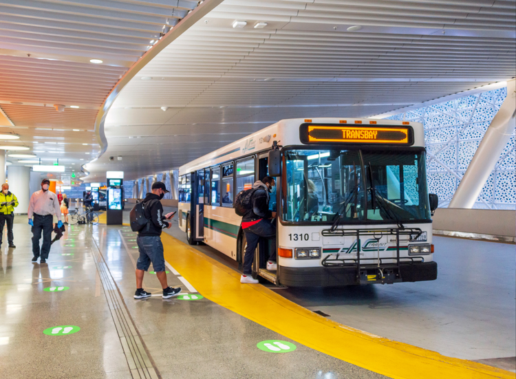 Man boards a bus at the Transbay Terminal