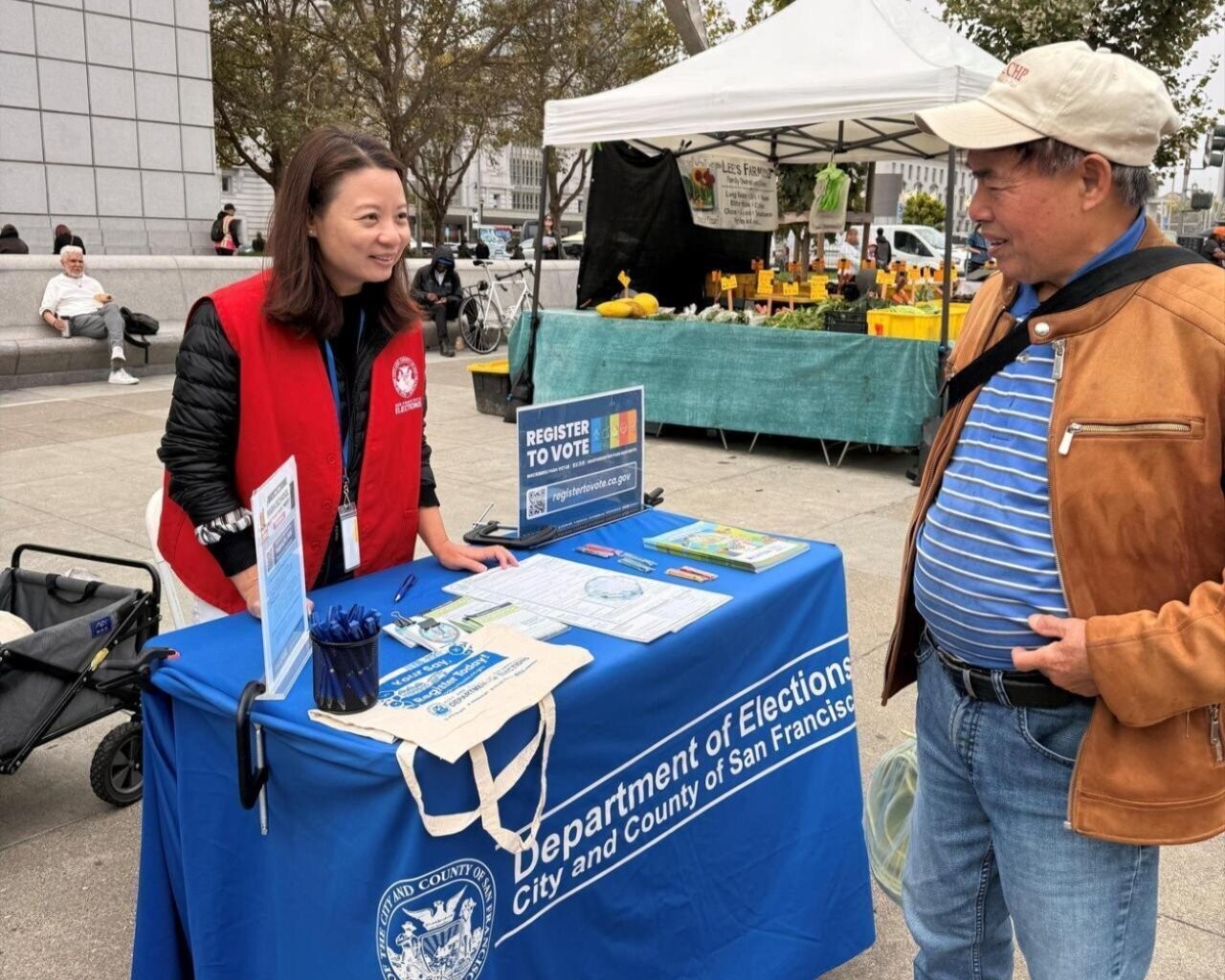 SF outreach member speaking with an SF resident at the Farmers Market