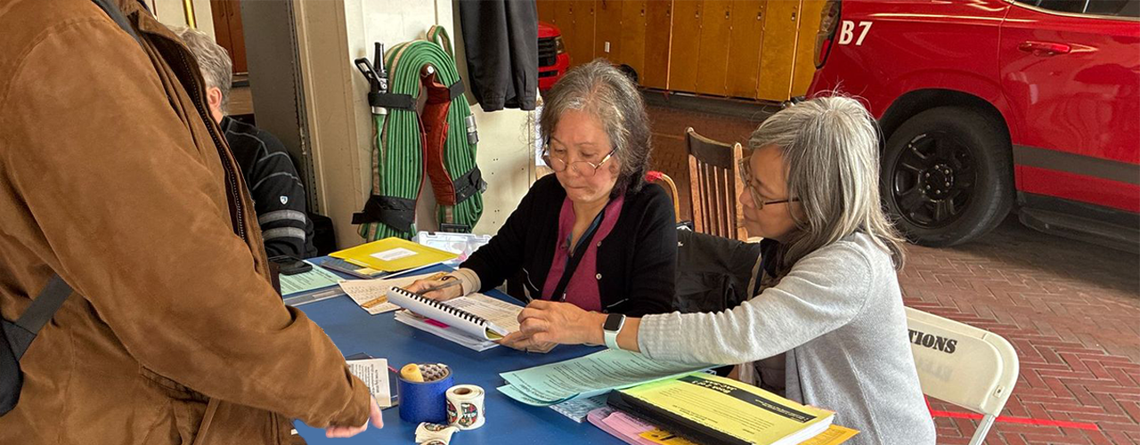 2 Bilingual Poll Workers assisting a San Francisco Voter.