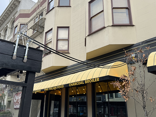 photo of electrical cords connecting from a parklet to a building