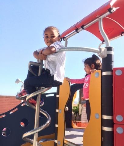 Child plays on the playground set at the new Booker T. Washington Center