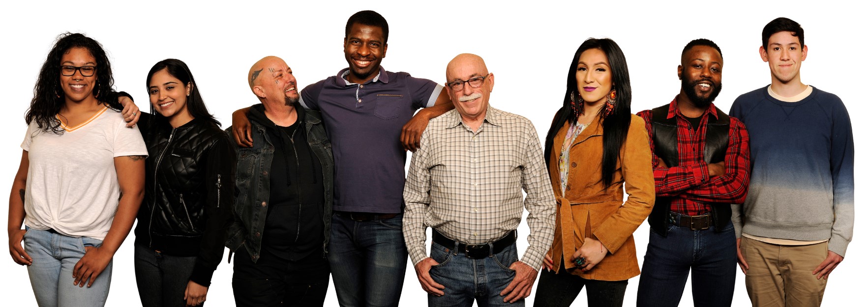 a group of 8 people of diverse communities and genders facing the camera