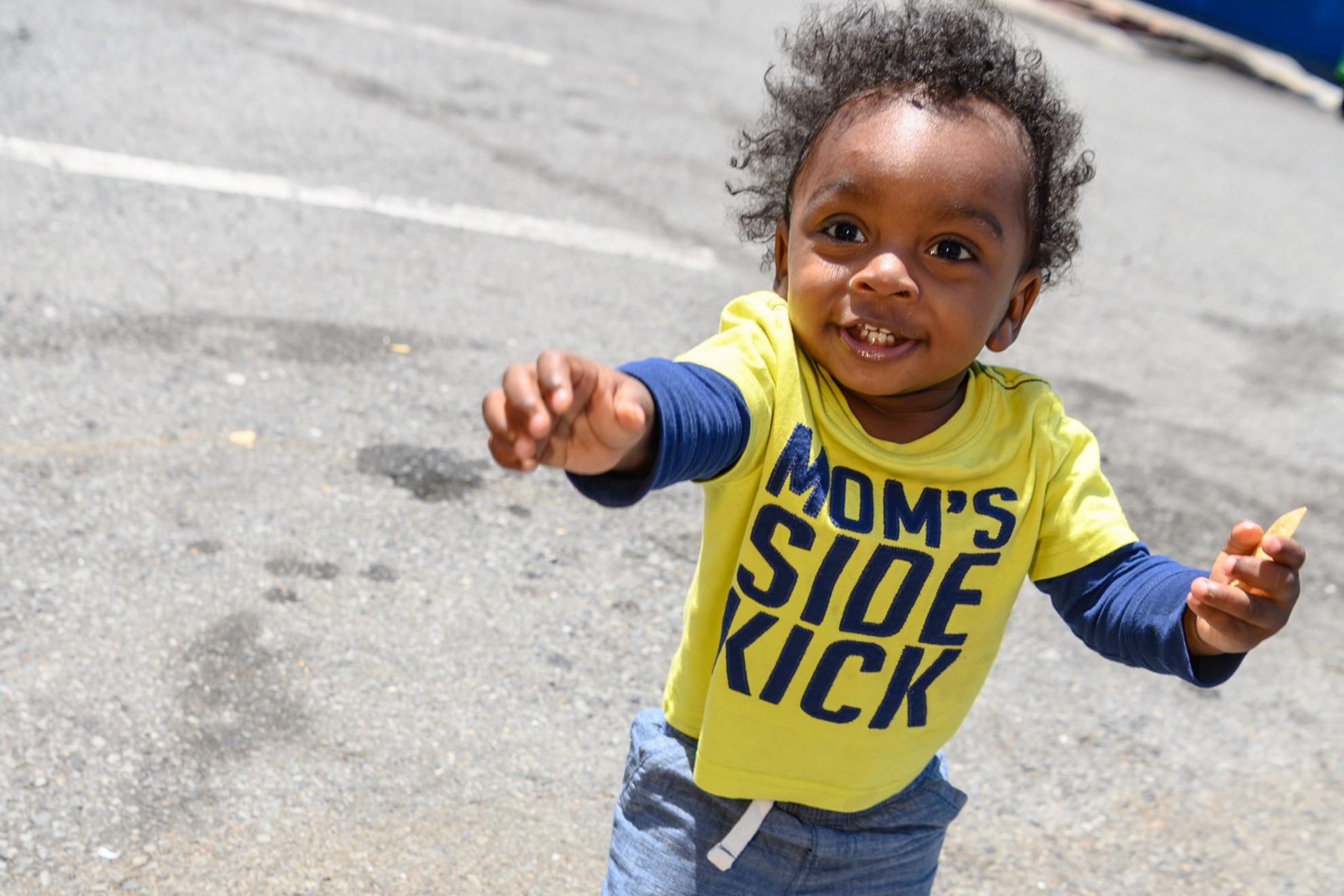 A toddler running towards the camera.