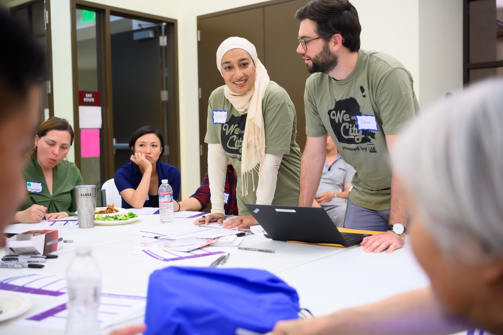 Two researchers talking to a group of people.