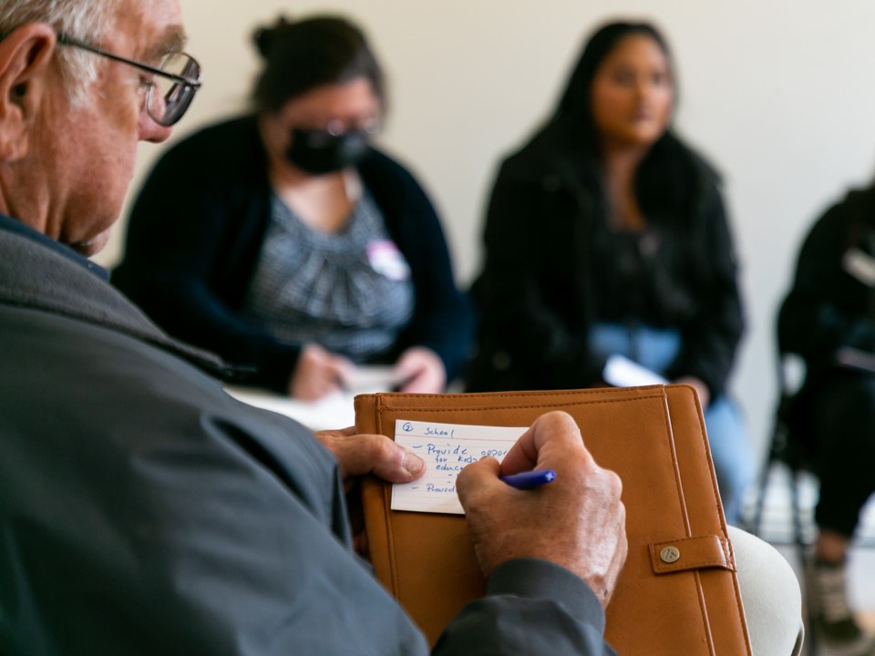 a man writing on a piece of paper