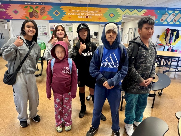 A group of youth standing in a classroom