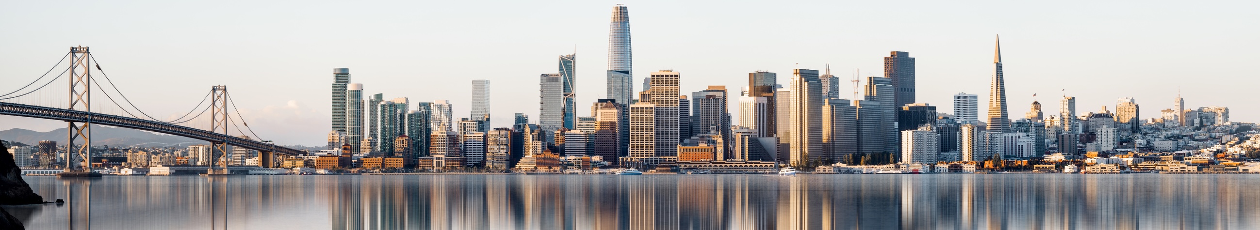 Skyline of San Francisco and reflection of the buildings in the water during sunrise