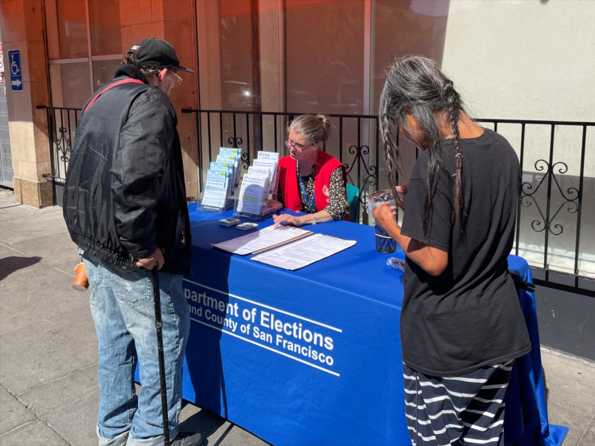 Two residents of San Francisco speaking with an Elections Outreach member.