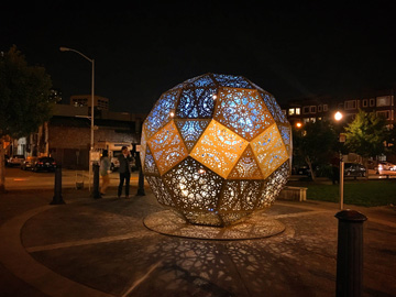 Outdoor installation in Hayes Valley featuring temporary public art sculptures placed in a small urban park setting, surrounded by buildings and greenery.