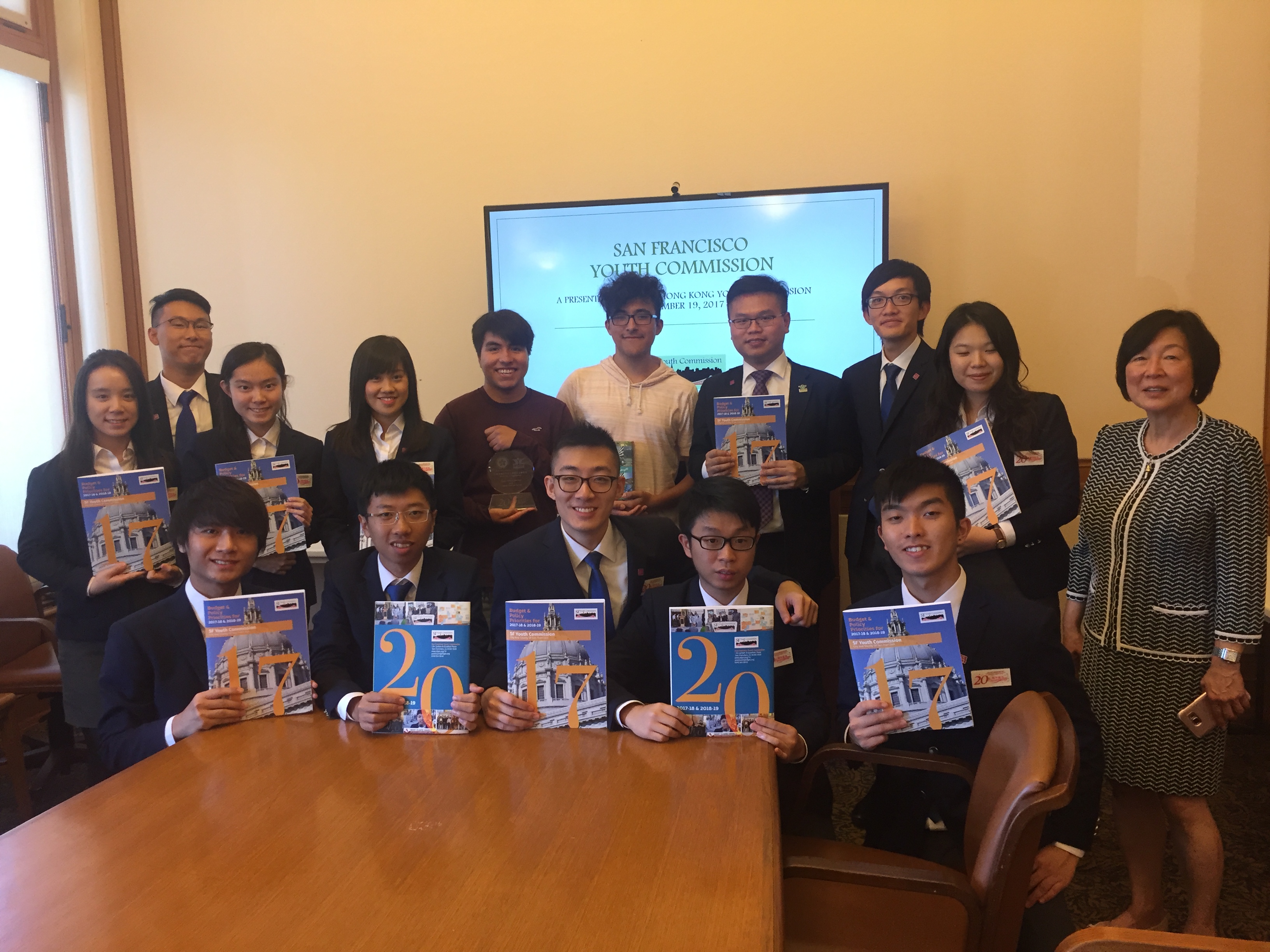 Picture of Youth Commissioners with students from Hong Kong taking a picture with a Budget and Policy Priorities Report