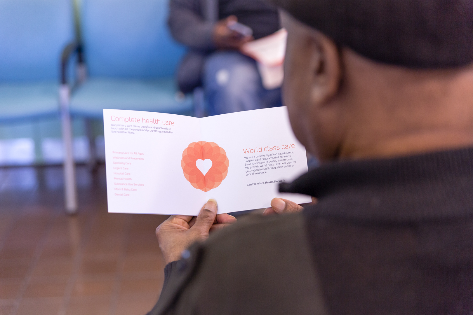 over the shoulder look at someone looking at san francisco health network brochure