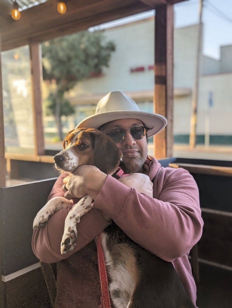 Ketan Hazari holding his dog.