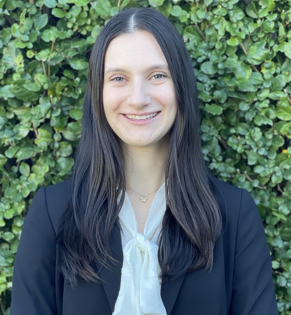 woman in front of leaves