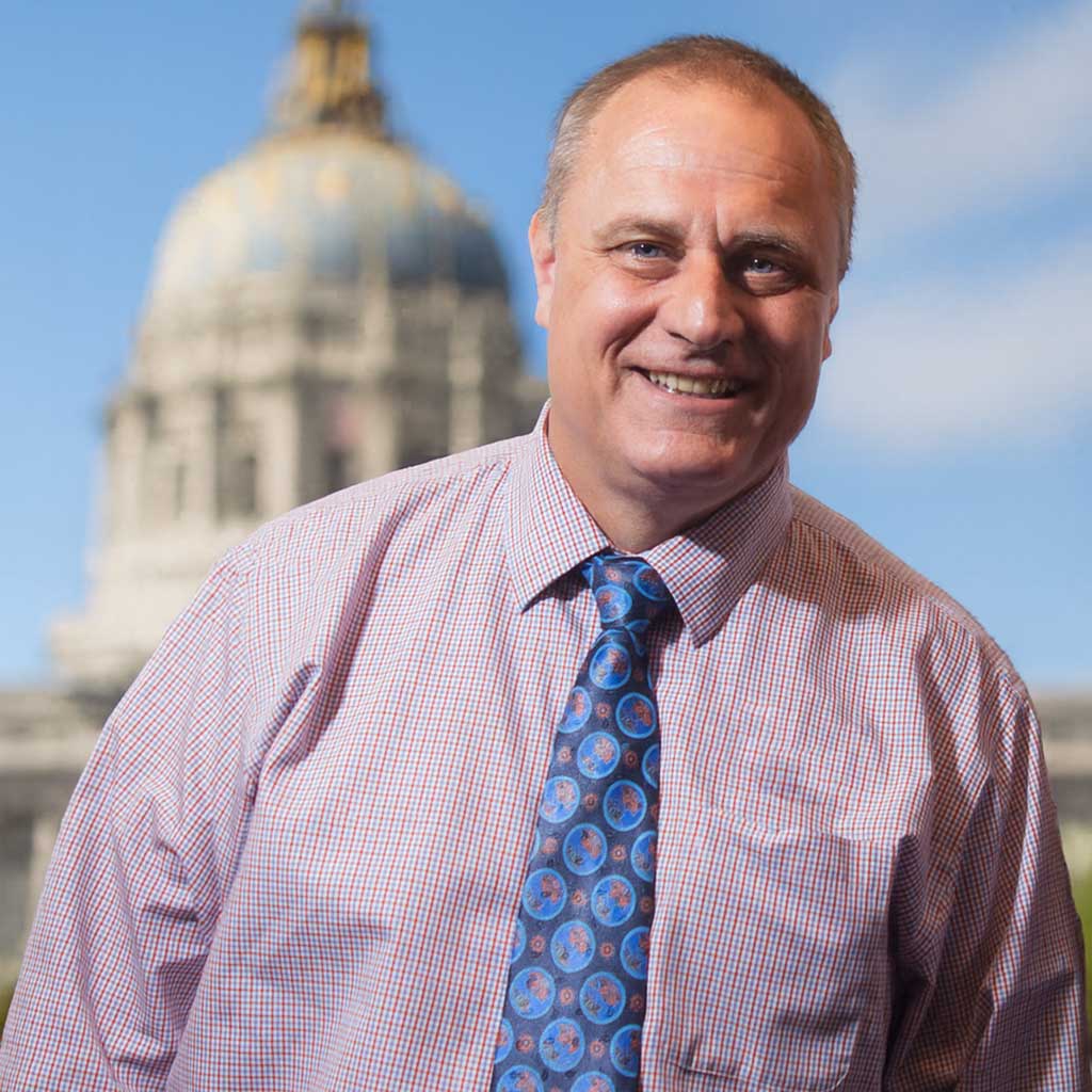 John Arntz smiling for a photo.