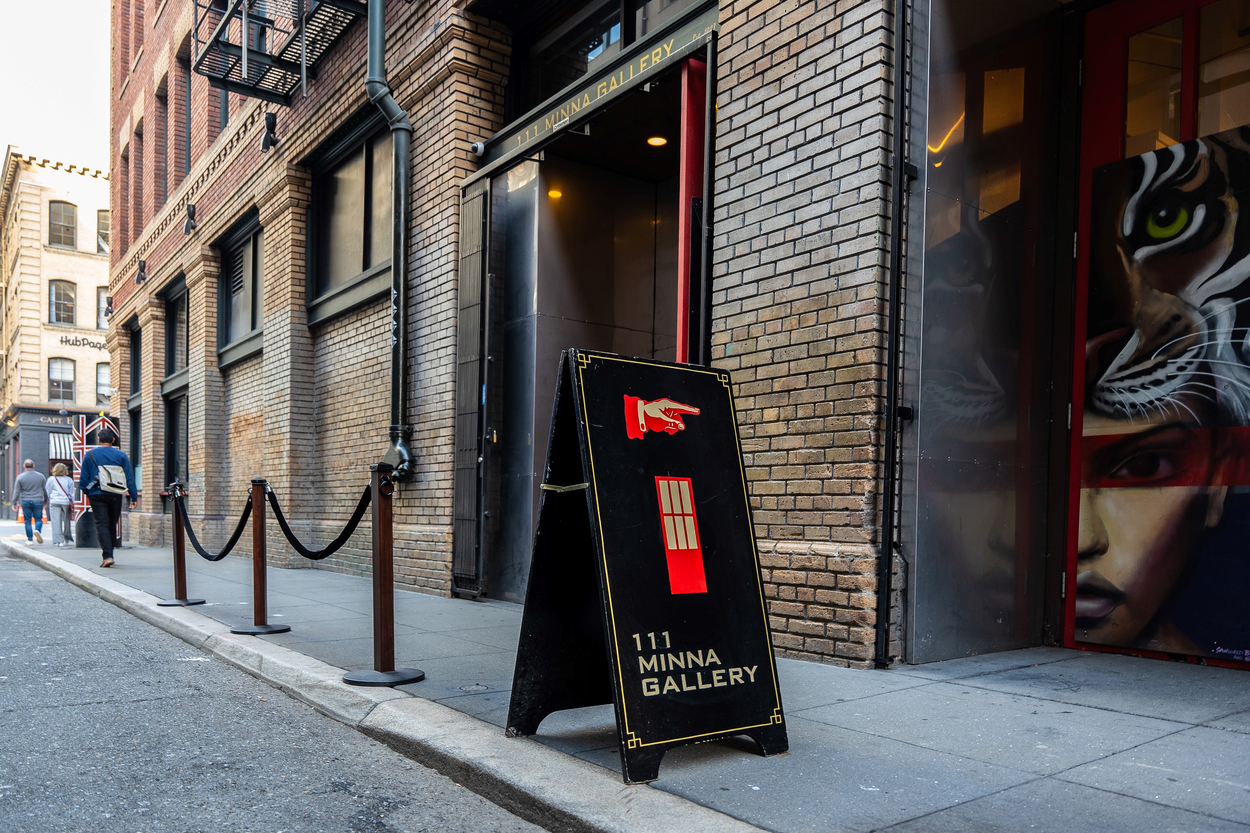 A-frame sign and storefront of 111 Minna Gallery