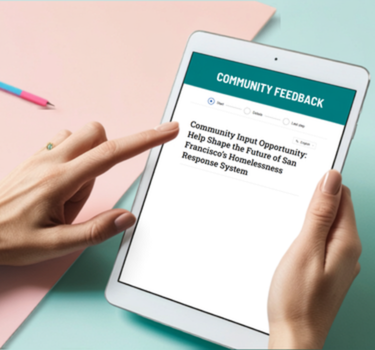 Hands holding a tablet that displays a webpage titled “Community Feedback,” with a form labeled “Community Input Opportunity: Help Shape the Future of San Francisco’s Homelessness Response System.”