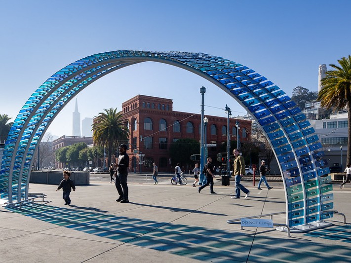 Blue sculptural installation titled Mareas by Ana Teresa Fernandez at Pier 27 in front of San Francisco skyline.