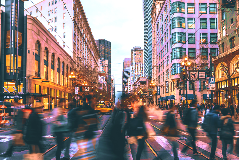 Blurry people crossing Market street in San Francisco