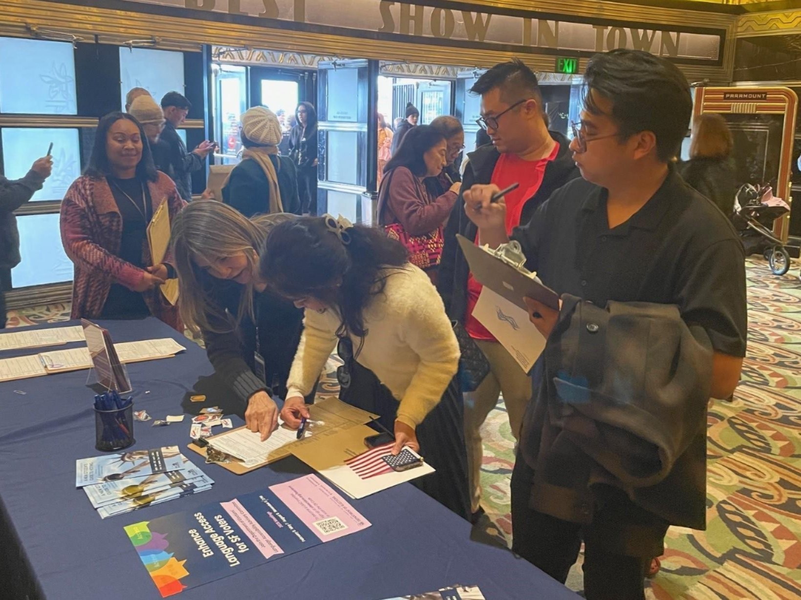 An Elections Staff member helping new US citizens register to vote.
