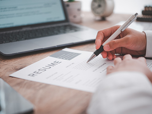 Person filling out a resume