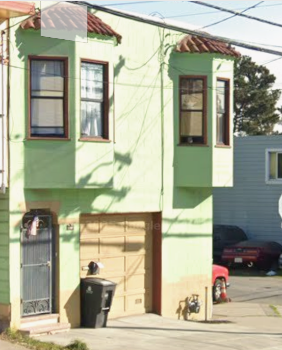 Light green house with arched front door entrance and yellow garage door - Phatt Chance Program located here