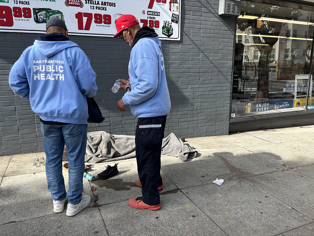 Public health workers with person on the street