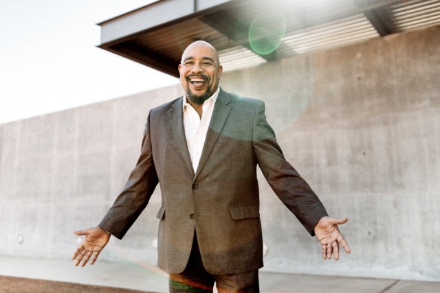 Image of Ralph Remington Smiling with spread open arms