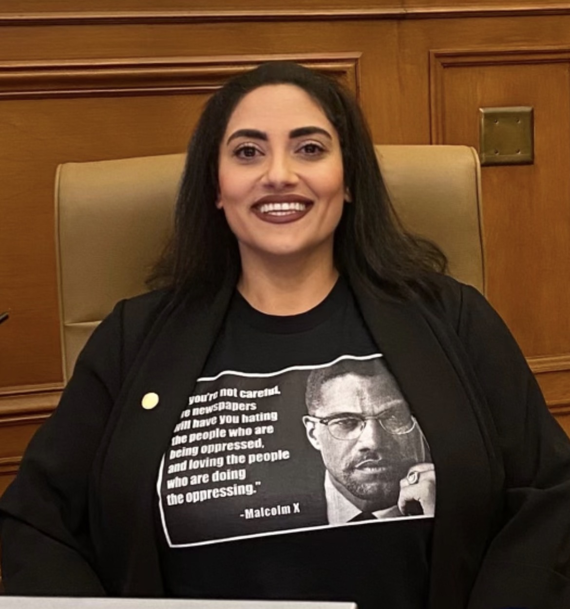 Sophia Andary is smiling sitting in a chair at City Hall.