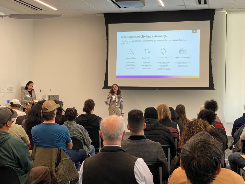 City staff presenting information about city contracting processes to a group of small business owners.