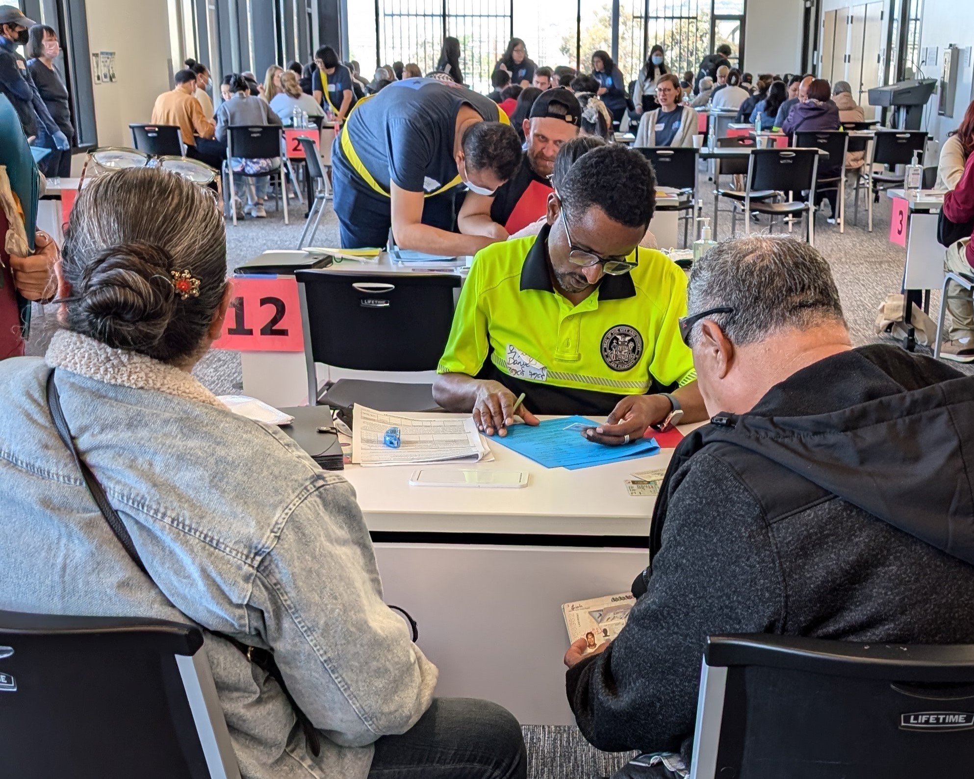 A volunteer helps someone apply for U.S. citizenship during a free workshop
