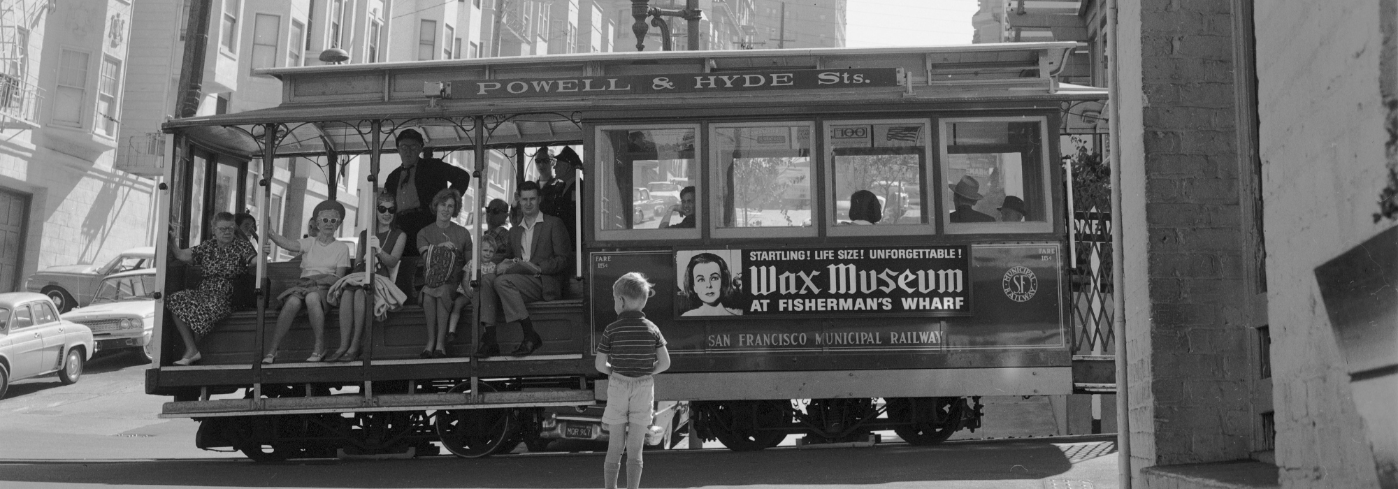 Black and White photo of Cable Car with Passengers Passing Washington Mason Cable Car House October 7, 1965