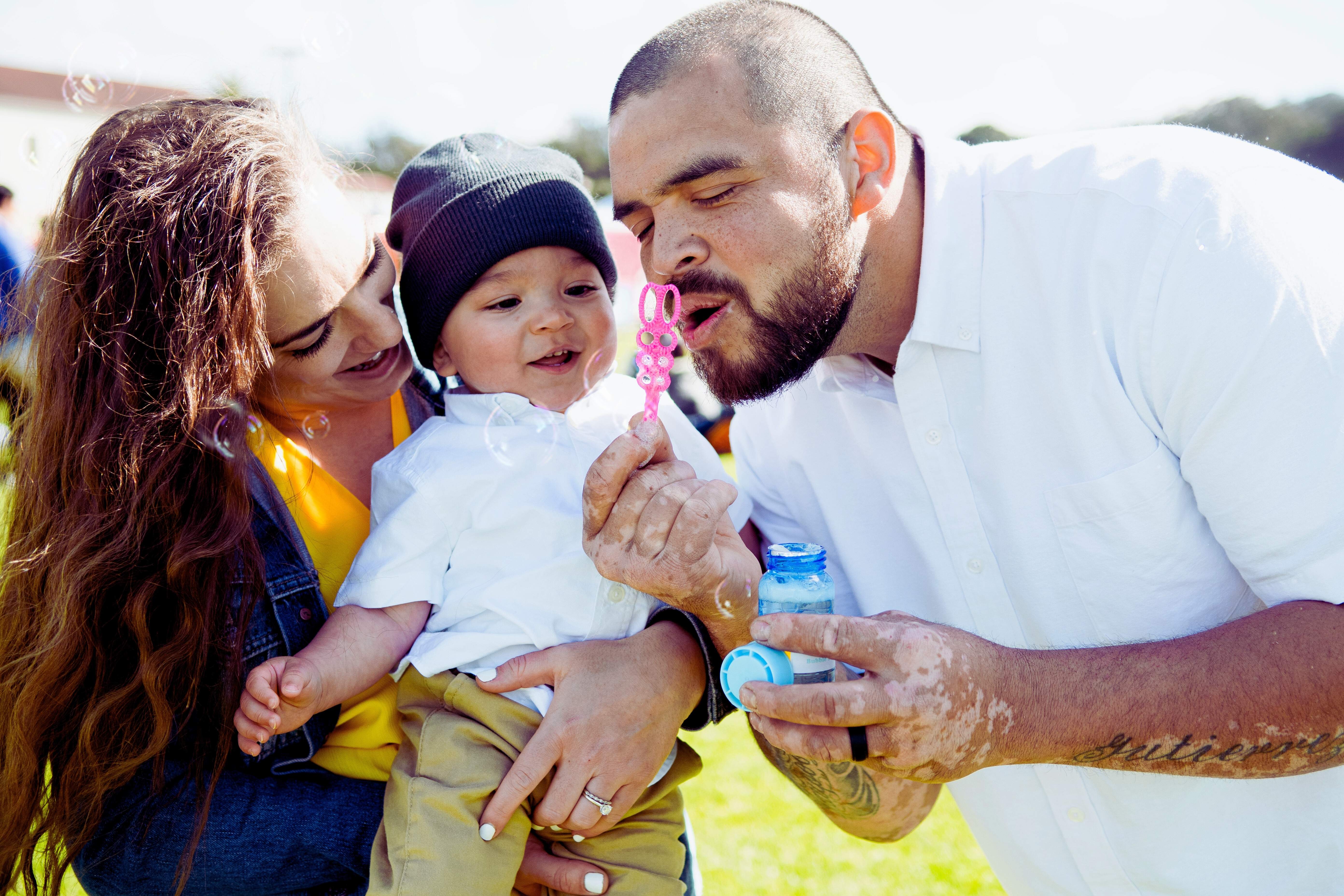Family blowing bubbles in the park