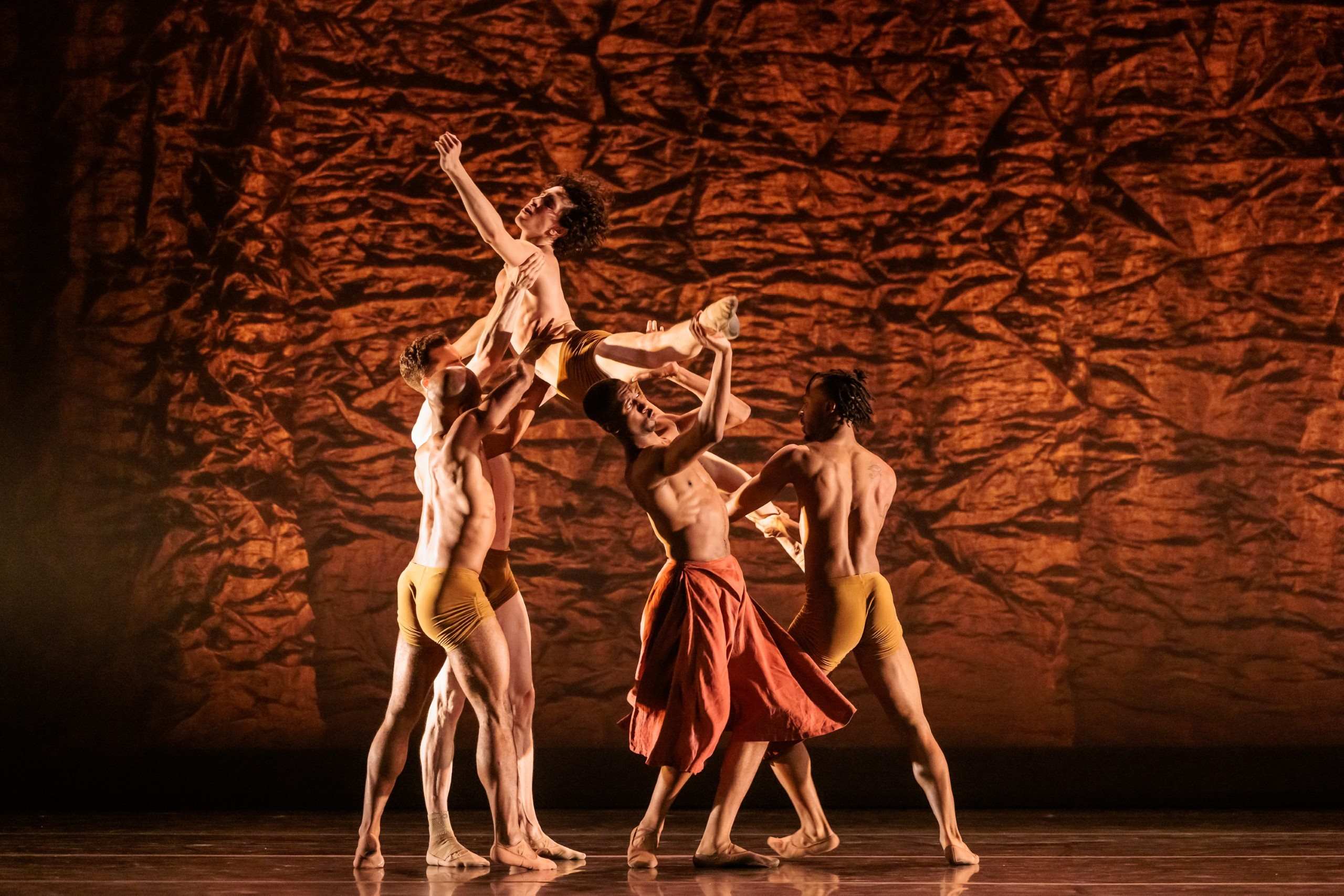 Alonzo King Ballet dancers on stage in a circular formation
