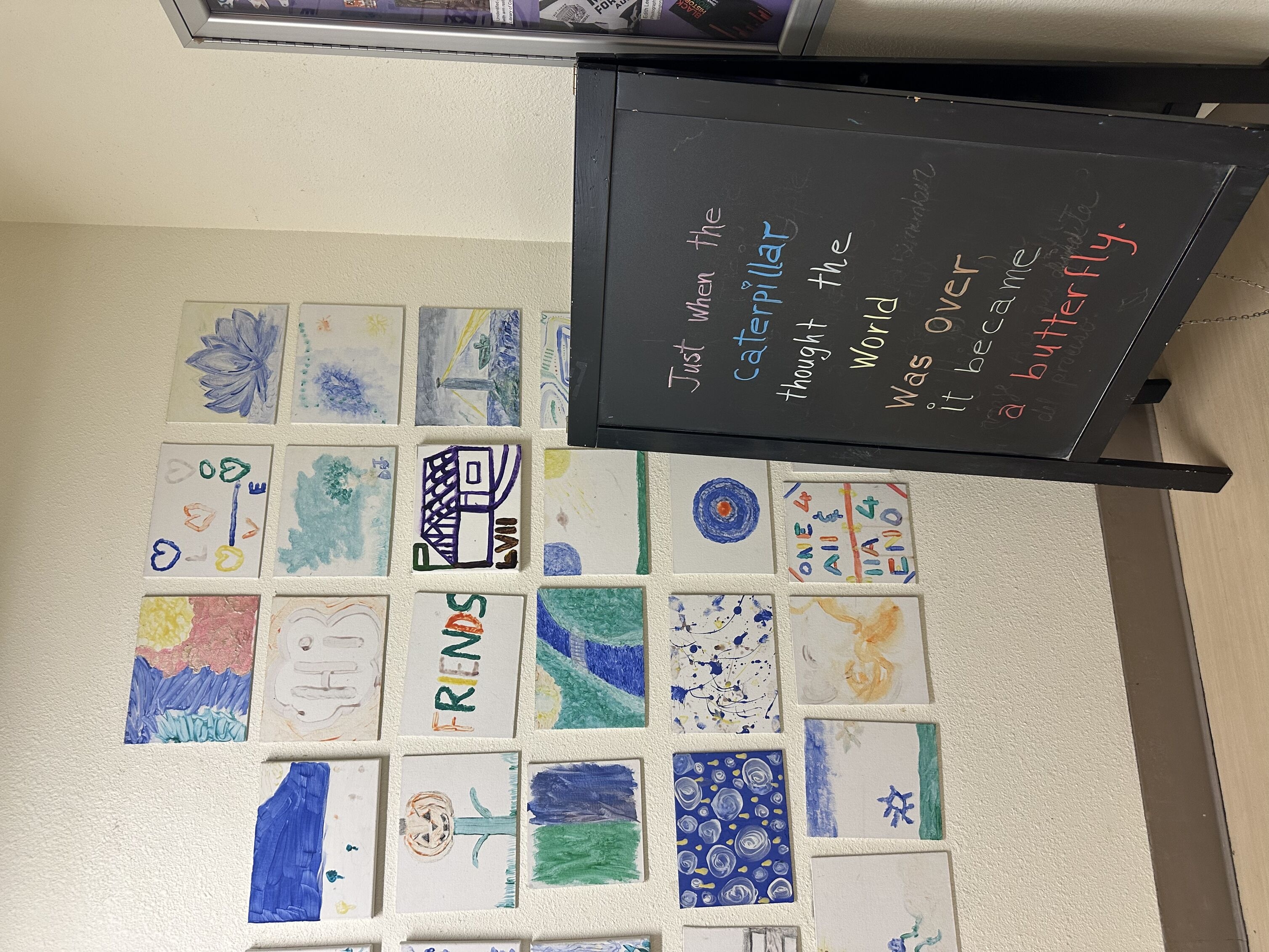 positive quote on chalkboard "just when the caterpillar though the world was over it came a butterfly"