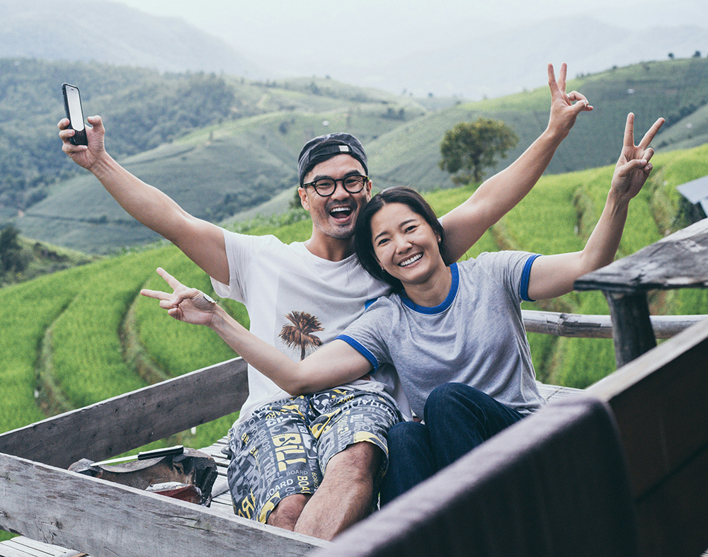 man and woman on vacation in green hills