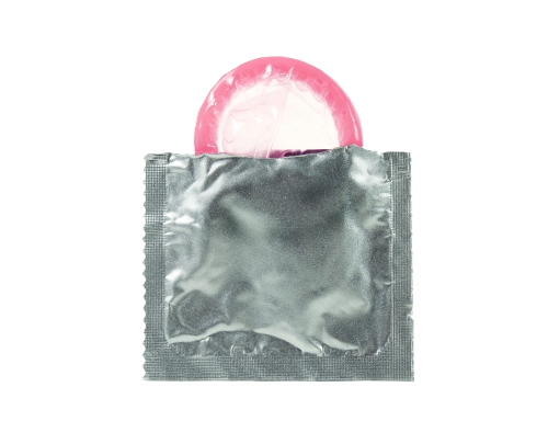 a pink condom partly pulled out of a silver foil wrapper