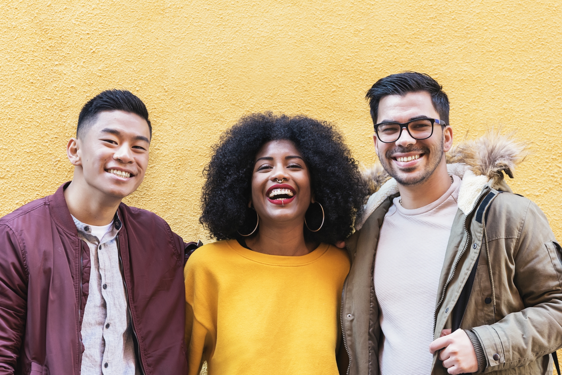 group of 3 people smiling toward camera