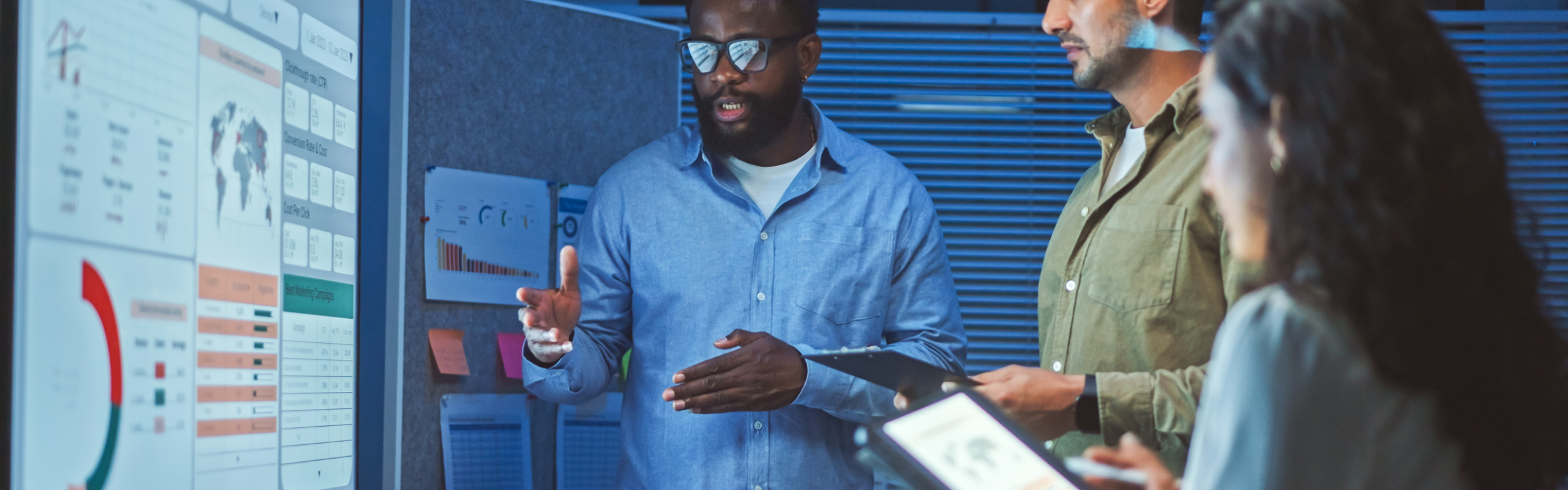 A team of multiethnic developers is meeting to review the data analysis of marketing