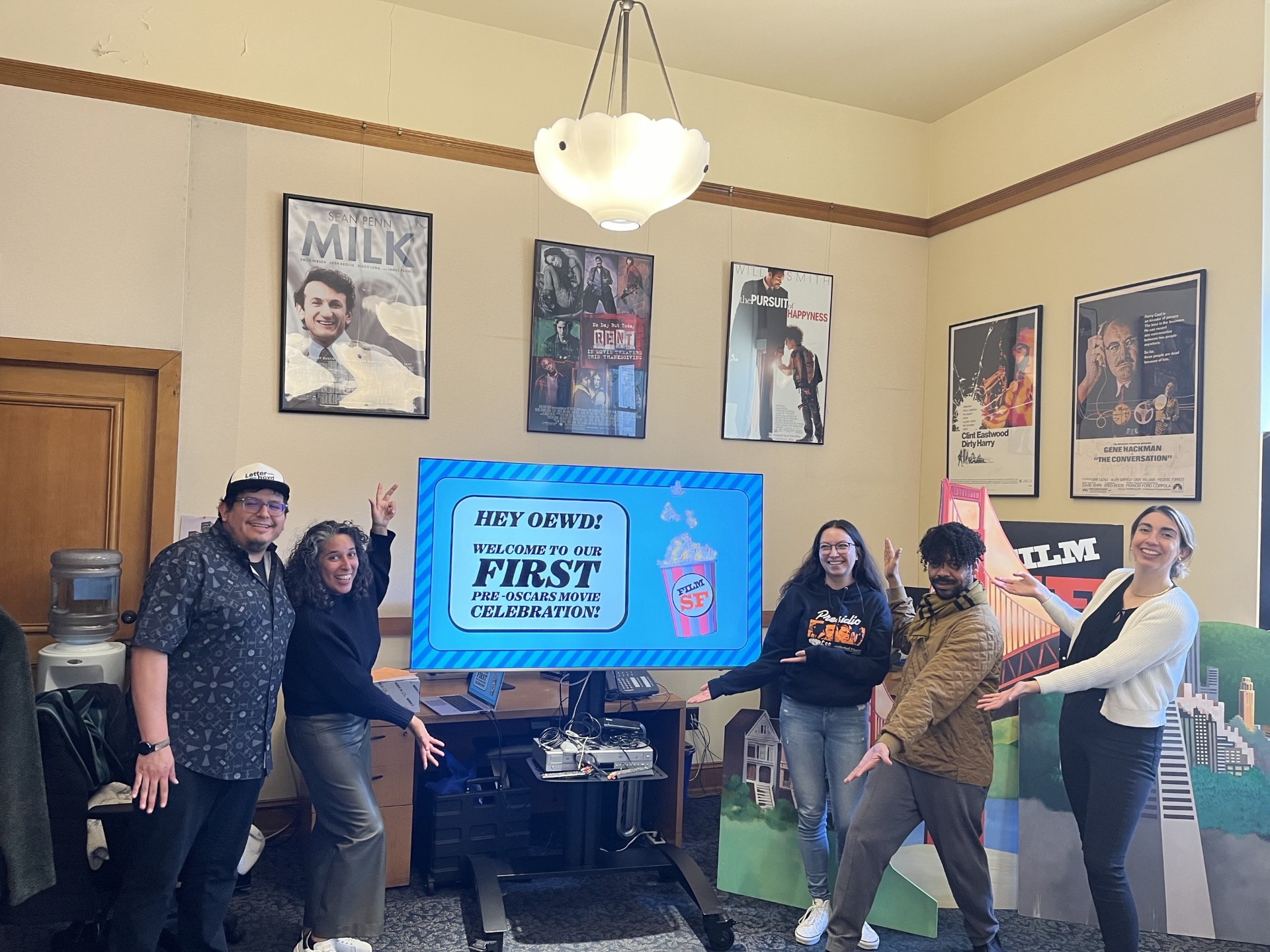 The Film SF staff posing in front a trivia slideshow
