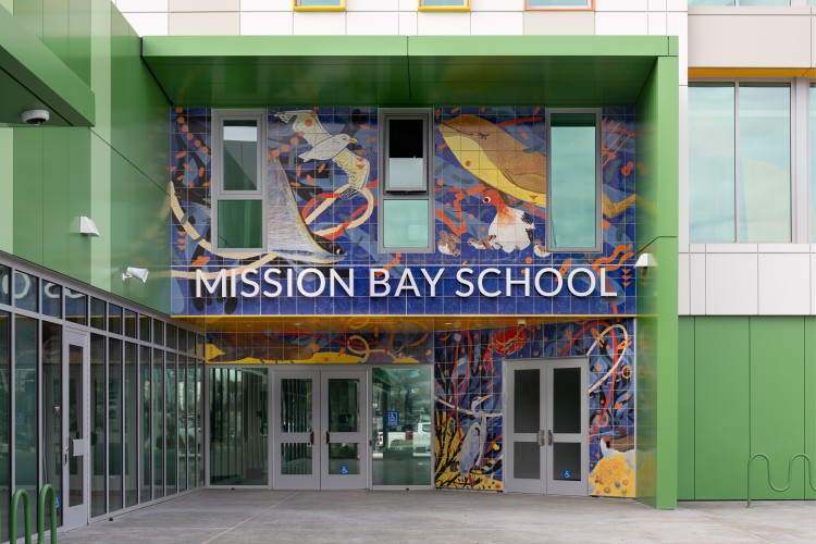 yellow blue orange and white porcelain tile mural depicted above the signage 'mission bay school'
