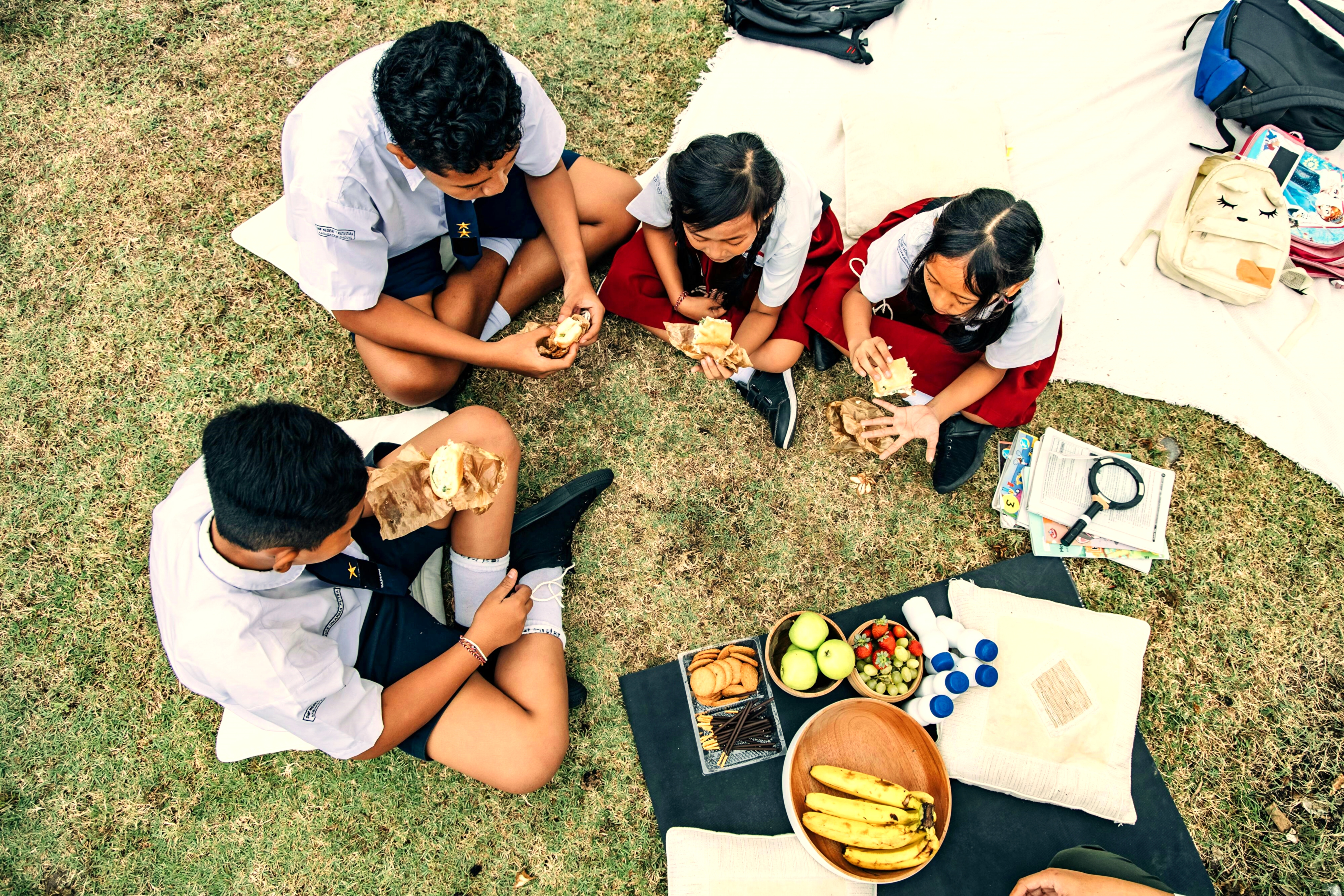 kids eating on grass