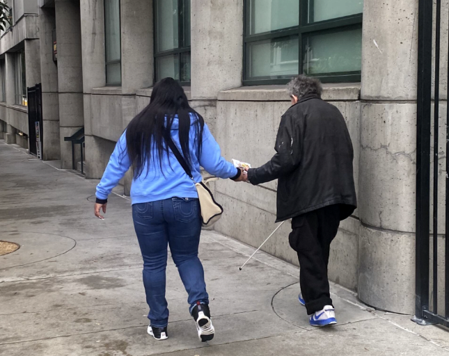 supportive housing nurse walking on street with client