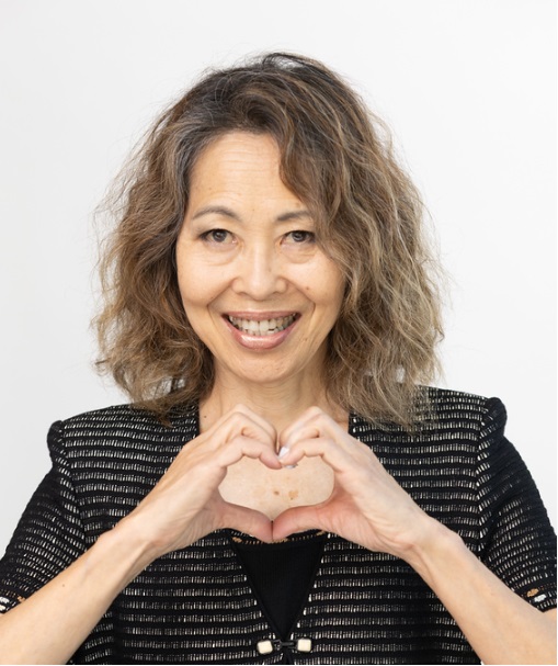 woman holding hands in heart shape